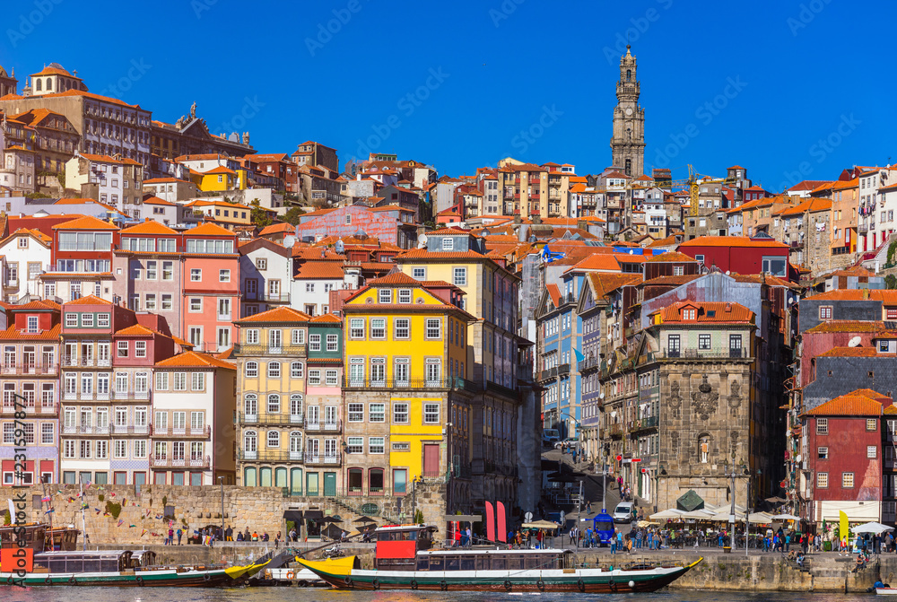 Colorful houses of Porto Ribeira, traditional facades, old multi-colored houses with red roof tiles on the embankment in the city of Porto, Portugal