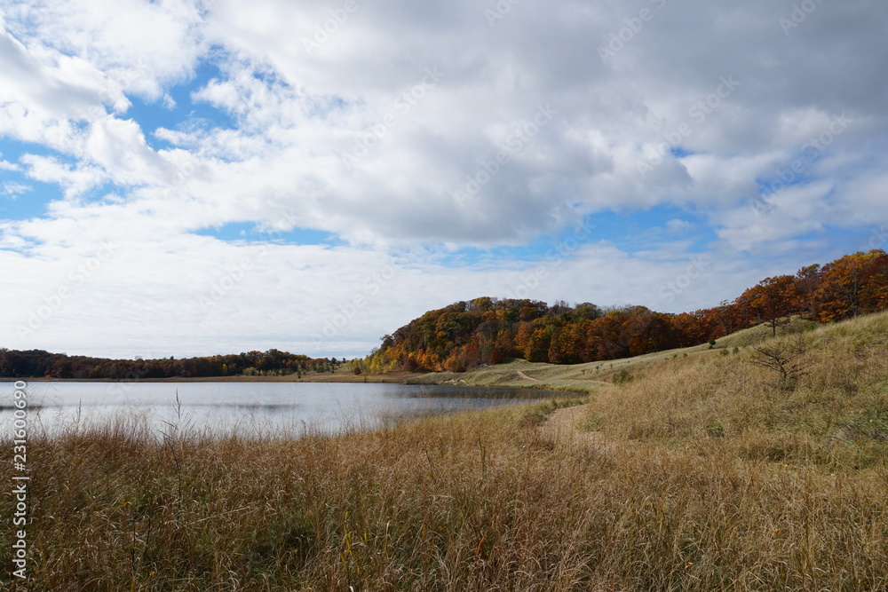 Fall landscape in the Midwest with lake, clouds, and beach grass