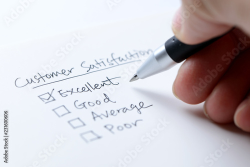 Business hand evaluate excellent on customer satisfaction form