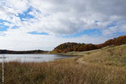 Fall landscape in the Midwest with lake, clouds, and beach grass