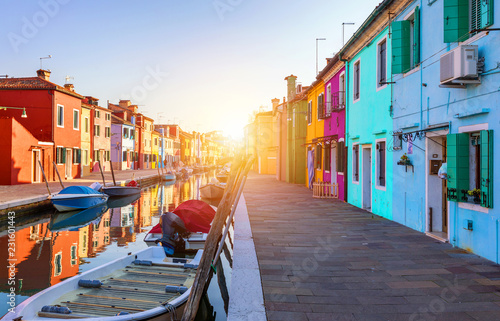 Beautiful view of the canals of Burano with boats and beautiful, colorful buildings. Burano village is famous for its colorful houses. Venice, Italy. © daliu