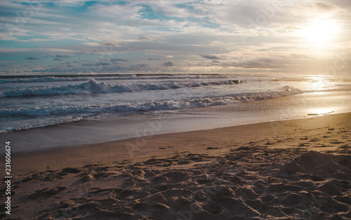 Waves lap at the beach during sunset in Santa Teresa  Costa Rica