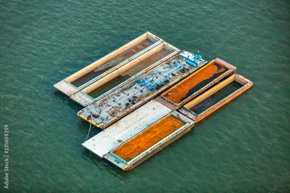 Sea barge with sand after harvesting at day