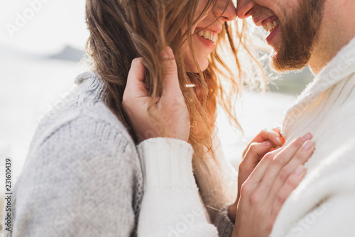 Close-up portrait of man and woman together, happy, looking at each other. Smiling, kissing and laughing