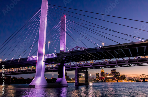 Louisville, Kentucky, USA downtown skyline from under the Abraham Lincoln bridge on the Ohio River at dusk. photo