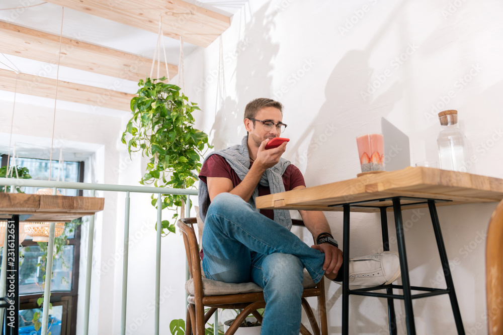 Phone call. Handsome stylish smart entrepreneur having important phone call with business partner Phone call. Handsome stylish smart entrepreneur having important phone call with business partner