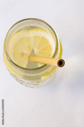 Lemon water and bamboo drinking straw.