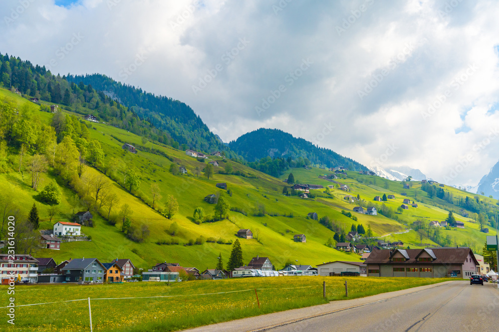 Obraz premium Countryside road in village, Alt Sankt Johann, Sankt Gallen, Switzerland