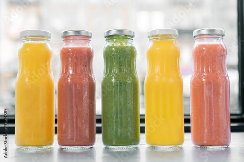 Fruit juices. Freshly squeezed fruit juices standing near the window in cafeteria early in the morning