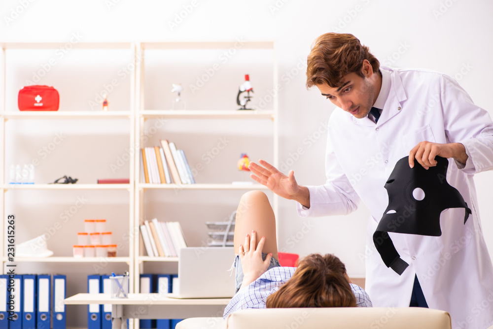 Young female patient visiting male doctor traumatologist Young female patient visiting male doctor traumatologist