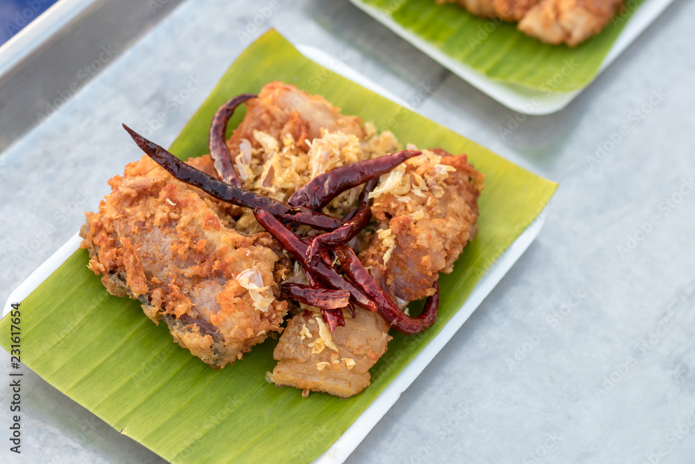 Pickled fish fried on banana leaf in foam box. Pickled fish fried on banana leaf in foam box.