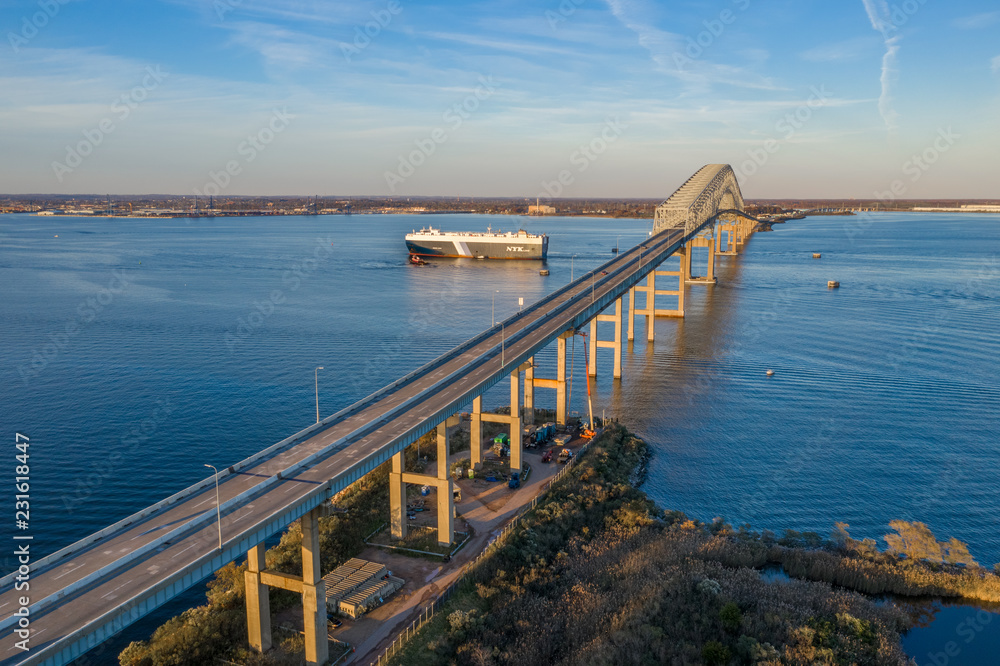 Aerial view of Francis Scott Key Bay bridge over the Patapsco river in Baltimore Maryland with ships Aerial view of Francis Scott Key Bay bridge over the Patapsco river in Baltimore Maryland with ships