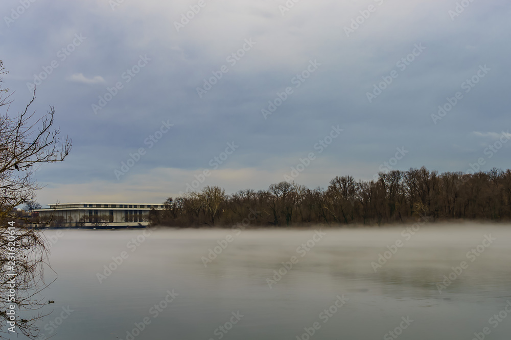 John F. Kennedy Center for the Performing Arts across Potomac River, winter fog on the water.