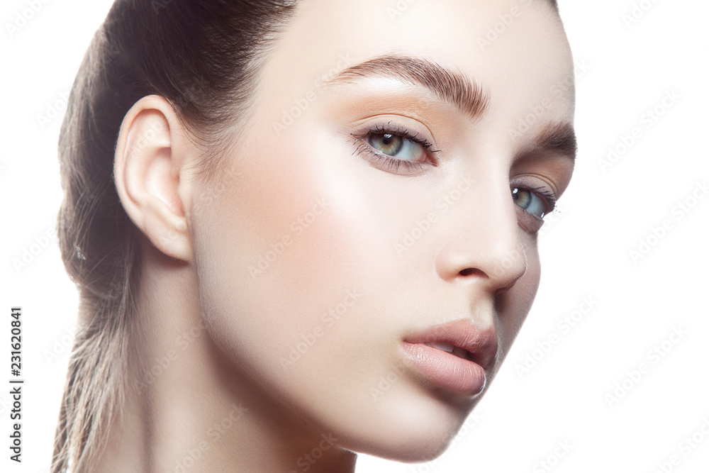 Beauty girl face with fresh natural lips, nude make-up. White background. Copy space