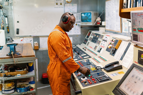 Fotografija Marine engineer officer in engine control room ECR