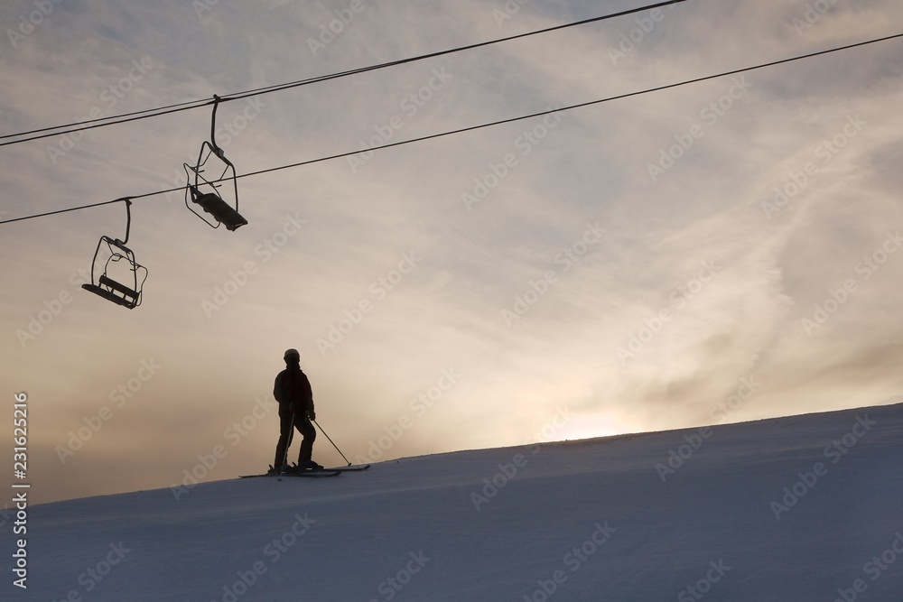 Skier silhouette against glowing sky Skier silhouette against glowing sky