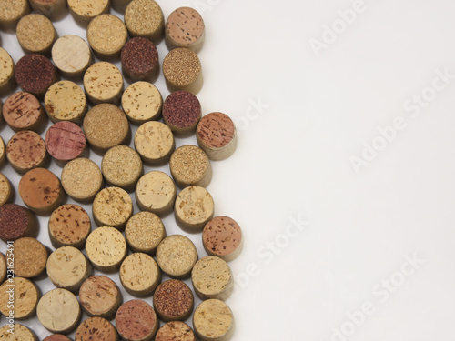Many wine corks are shown standing on end, with white copy space / text space to the right.
