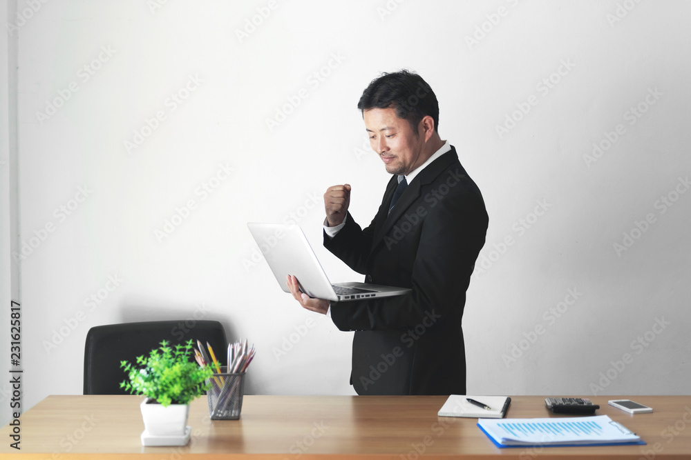 Happy young businessman is working in his office. Happy young businessman is working in his office.