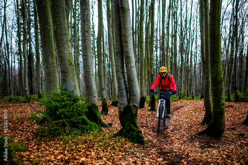 Mountain biking woman riding on bike in summer mountains forest landscape. Woman cycling MTB flow trail track. Outdoor sport activity.