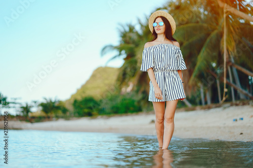 beautiful girl walking along the beach