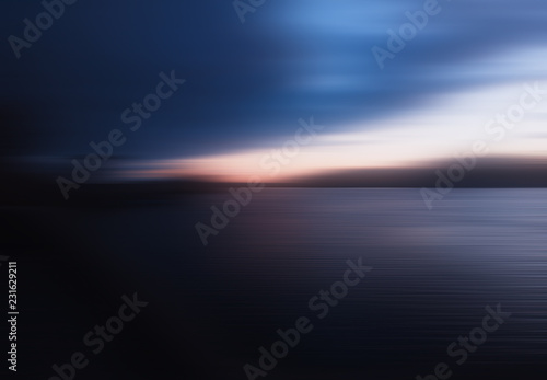 Horizontal motion blur sunset on river background