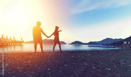 man and woman walking on the seashore silhouette Turkey Marmaris