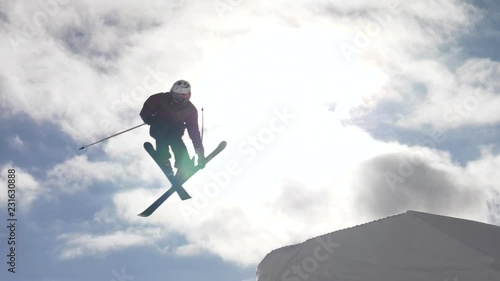 Slow motion - Freestyle skier jumping off springboard and doing a spin