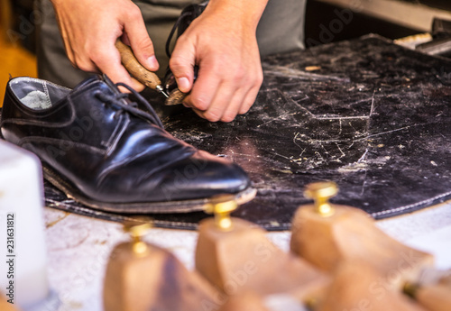 Young master repairs shoes. Close-up hands.