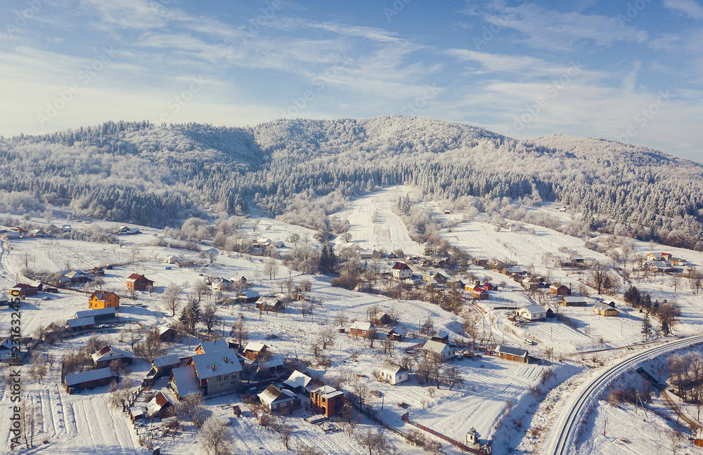 aerial view of a small town in the mountains during winter