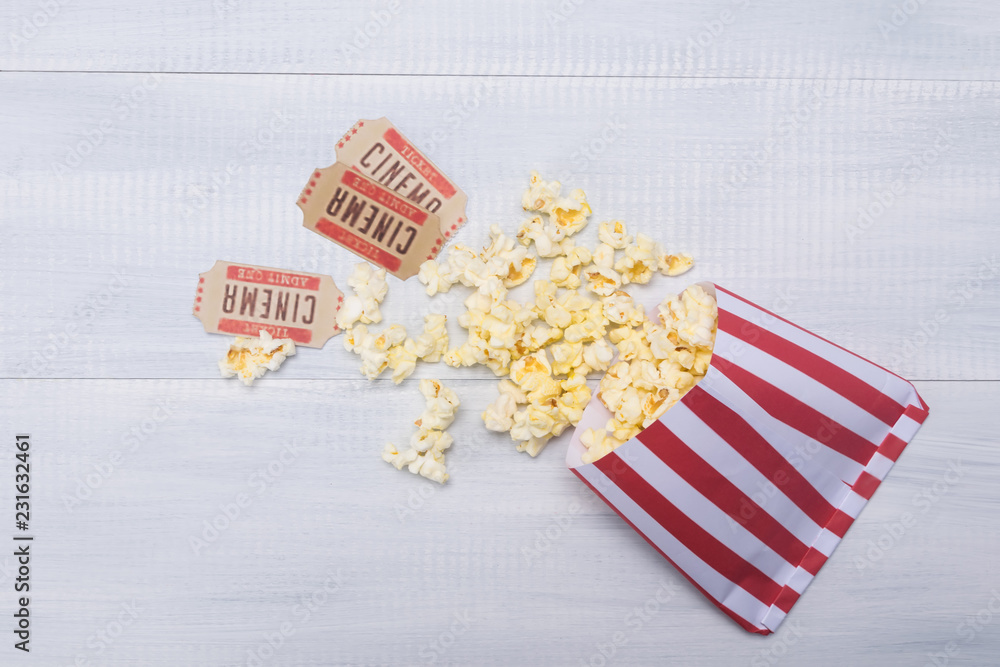 cinema popcorn packaging and two movie tickets