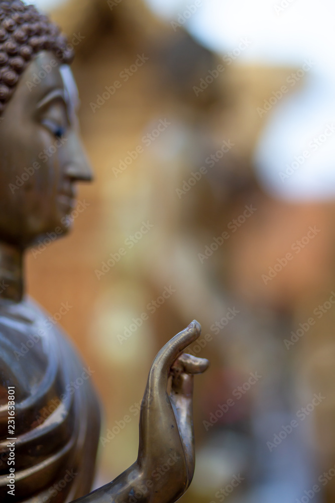 The bronz Buddha images with the others images in the temple and other decorative stuff in the royal temple in Thailand , blur background style. 