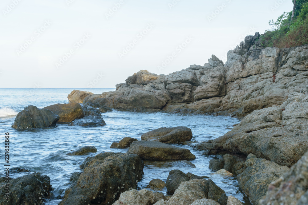 Rocks with Smooth Sea Water(wave) at Surin Beach, Phuket, Thailand Rocks with Smooth Sea Water(wave) at Surin Beach, Phuket, Thailand