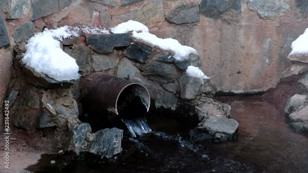 Close-up sewer drain from pipes during the winter Close-up sewer drain from pipes during the winter