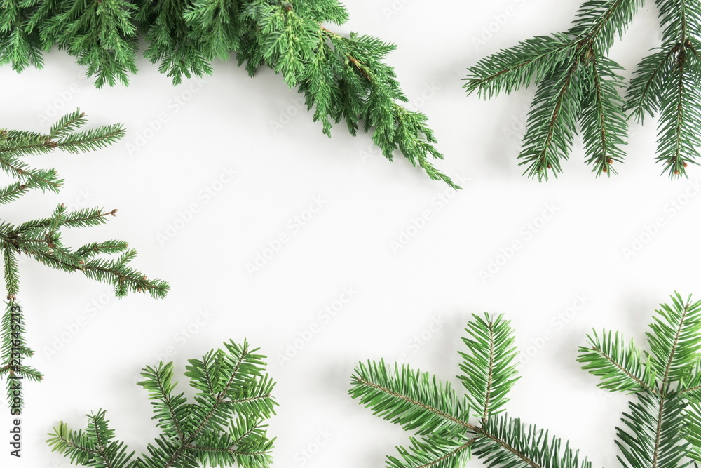 Christmas composition. Xmas frame made of coniferous tree branches on white background. Christmas, New Year, winter concept. Flat lay, top view, copy space 