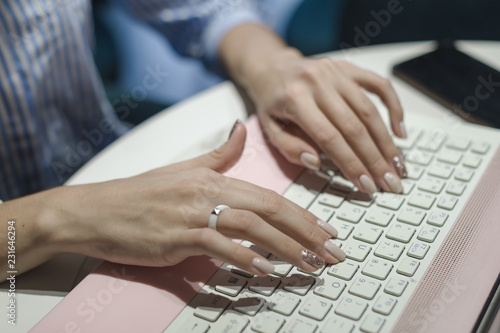 Workplace women working behind a laptop in a cafe. job online young beautiful brunette