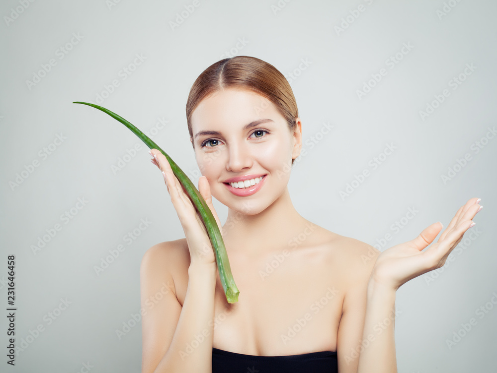 Healthy woman with aloe leaf showing empty copy space on the open hand Healthy woman with aloe leaf showing empty copy space on the open hand