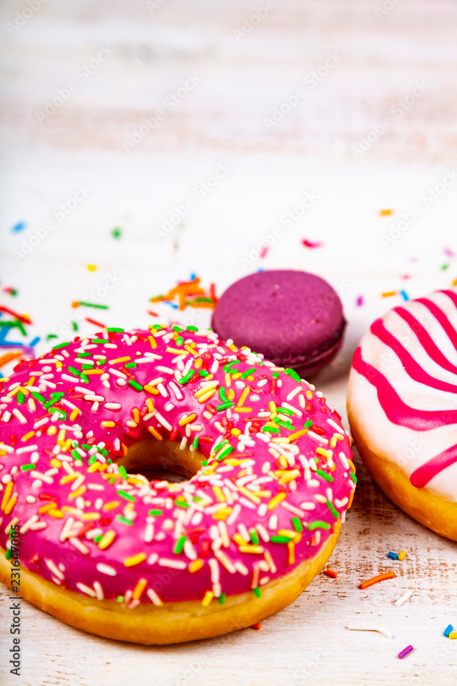 Donuts and macaroons on a wooden background Donuts and macaroons on a wooden background