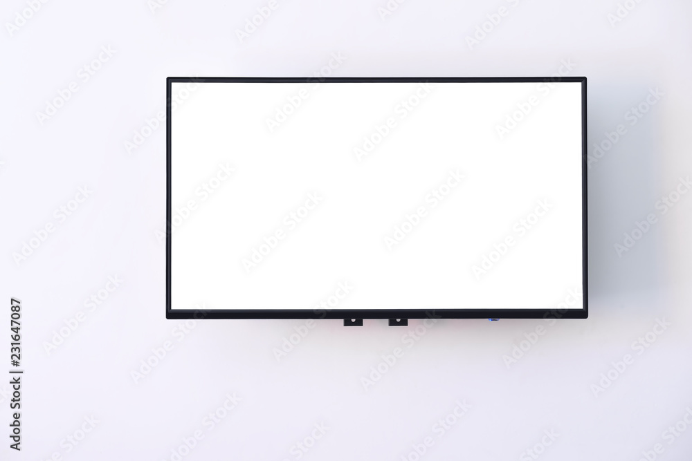 Naklejka premium White wide screen TV digital hanging on white wall background