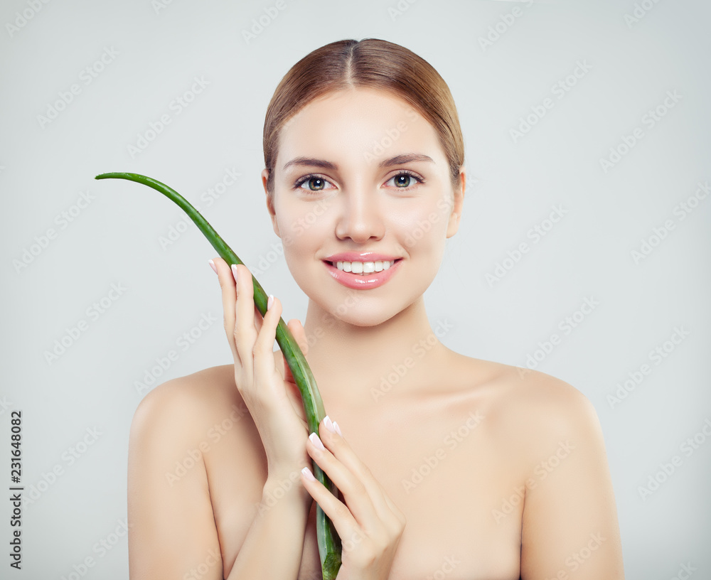 Young smiling woman with aloe vera leaf Young smiling woman with aloe vera leaf