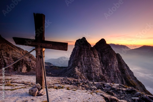 Summit cross of the third Watzmannkind in front of first and second Watzmannkind, sunrise, Watzmannkar, Watzmann, Berchtesgaden National Park, Berchtesgaden Alps, Schonau am Konigsee, Bavaria, Germany, Europe photo