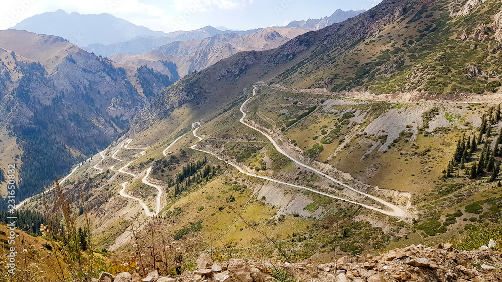 A gravel road with many turns through pass A gravel road with many turns through pass