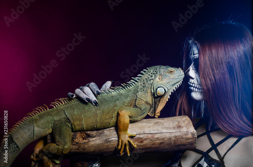 dead face girl and green iguana. Halloween.