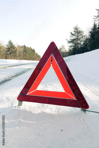 Emergency stop sign. Car on the winter road.