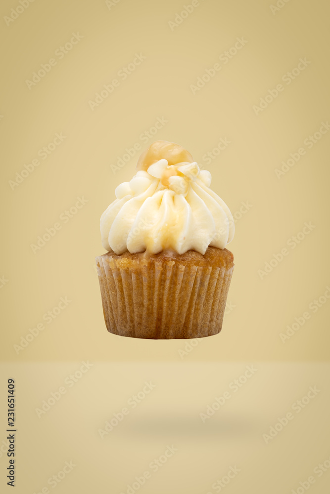 Macadamia cupcake flying on yellow background, idea minimal concept for new year and christmas holliday. Macadamia cupcake flying on yellow background, idea minimal concept for new year and christmas holliday.