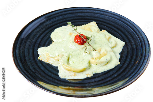 Ravioli with salmon in creamy sauce with Pesto isolated on white photo