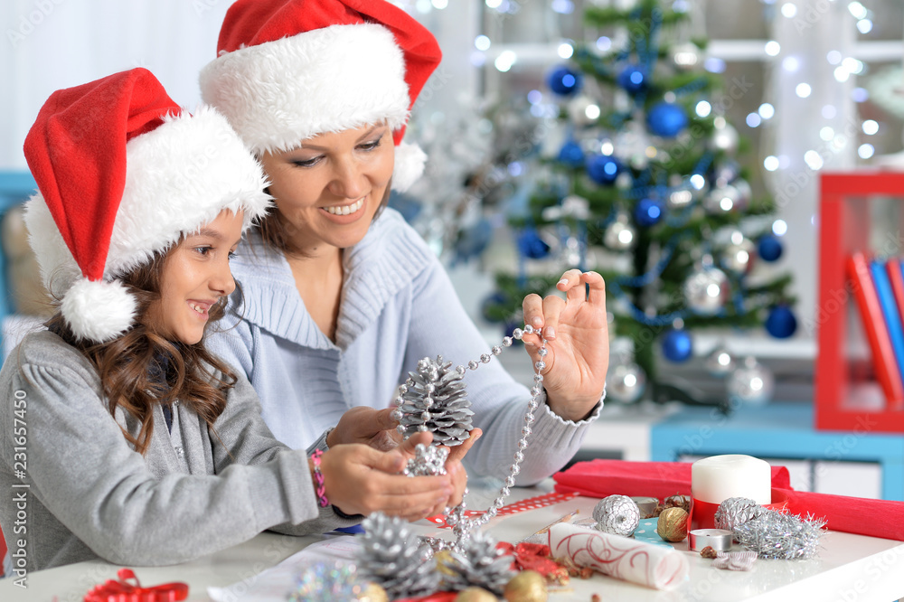 Portrait of mother and daughter preparing for Christmas Portrait of mother and daughter preparing for Christmas