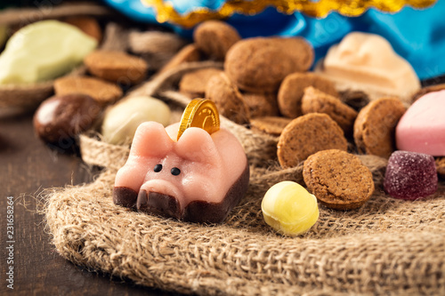 Dutch holiday 'Sinterklaas' greeting card with marzipan pig and traditional sweets kruidnoten, pepernoten for the. Festive concept. photo