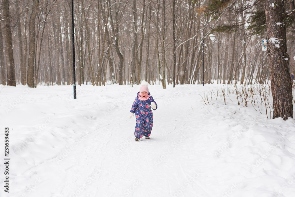 Children, winter and nature concept - Close up of adorable kid playing with snow in the park Children, winter and nature concept - Close up of adorable kid playing with snow in the park