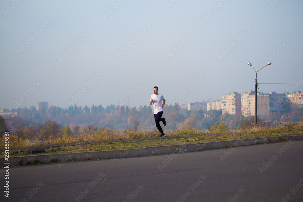 Obraz premium Man run at autumn morning. Healthy lifestyle concept