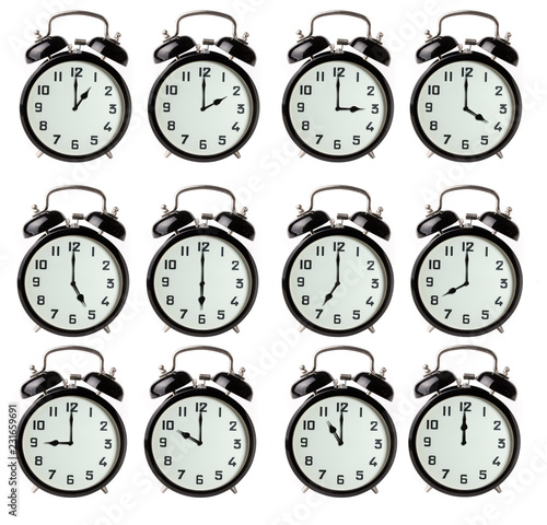 Iconic alarm clocks showing different hours isolated on white